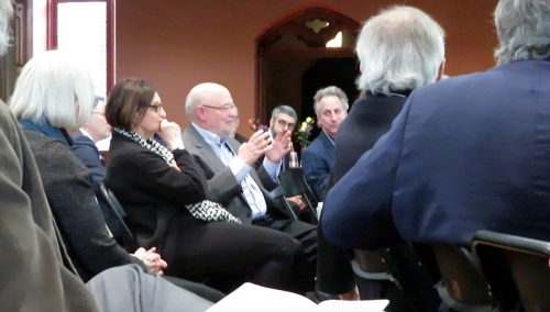 Leonard Barkan seated among an audience of people